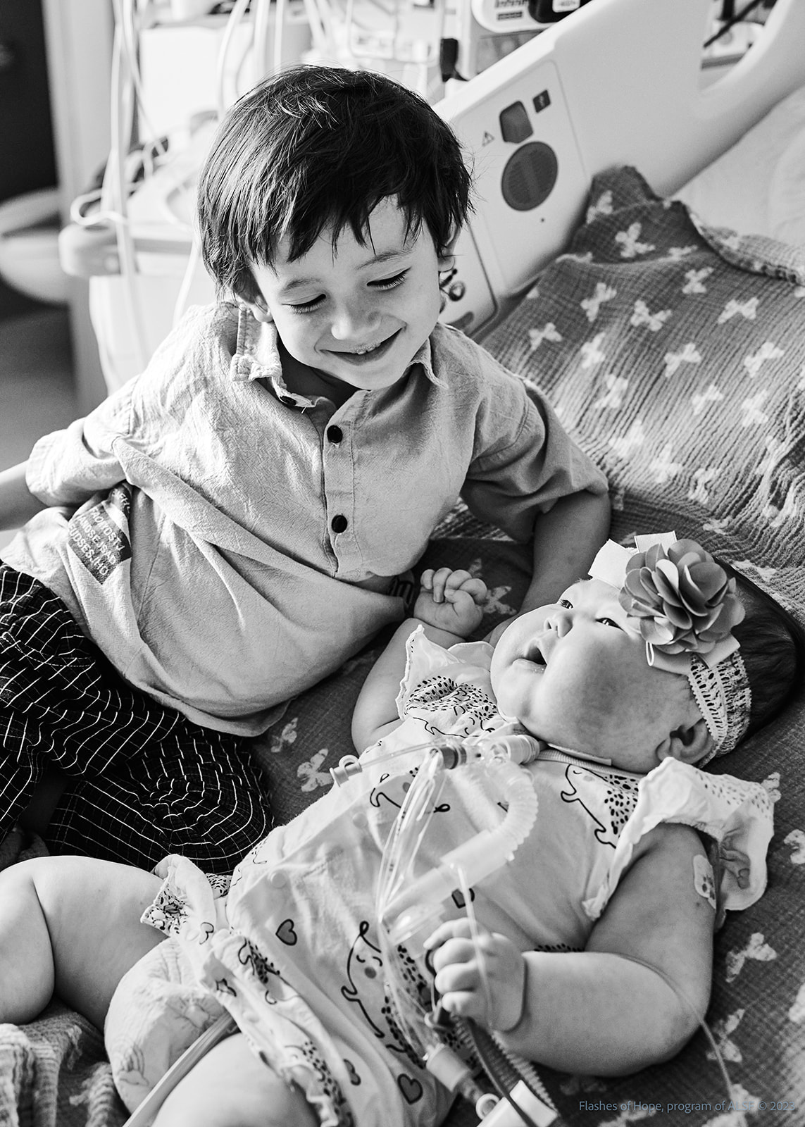 Black and white of Declan and Constance on a bed.